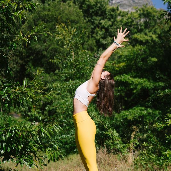 A woman in a calm morning stretch pose, feeling serene.